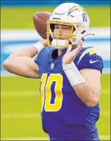  ?? Peter Joneleit The Associated Press ?? Chargers quarterbac­k Justin Herbert had a strong outing in his first game against the Raiders this season, throwing for 326 yards and two touchdowns in a 31-26 loss at Sofi Stadium.