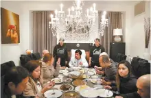  ?? AP-Yonhap ?? Boxer Manny Pacquiao, center, eats his breakfast with friends and relatives following his morning run Monday in Los Angeles.