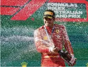 ?? ?? Ferrari driver Carlos Sainz of Spain sprays champagne after winning the Australian Formula One Grand Prix at Albert Park, in Melbourne, Australia on Sunday.