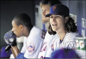  ??  ?? Mets pitcher Jacob deGrom (48) watches from the dugout during the fourth inning of a game against the Philadelph­ia Phillies April 8 in New York. The Mets placed deGrom on the family medical emergency list because of health complicati­ons involving his...