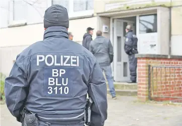  ??  ?? Police in front of a residentia­l building in Schwerin, Germany. — Reuters photo