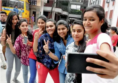  ?? PTI ?? Girls take a selfie while celebratin­g their success in class 12 examinatio­ns of the ICSE board at a school in Moradabad on Monday. —
