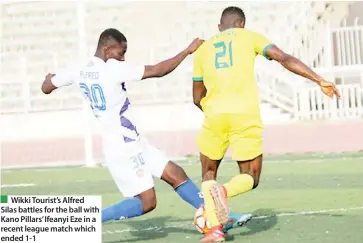  ?? ?? Wikki Tourist’s Alfred Silas battles for the ball with Kano Pillars’ Ifeanyi Eze in a recent league match which ended 1-1