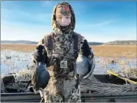  ?? COURTESY OF JERRY HOLDEN ?? Eleven-year-old Tanner Holden of Benton holds a brace of coots that will eventually grace his family’s dinner table.