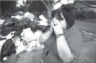  ?? Associated Press ?? Peggy Lanigan pauses as she speaks with The Associated Press on Wednesday in the aftermath of Hurricane Harvey in Houston. Harvey’s record-setting rains now have the potential to set records for the amount of debris one storm can produce.