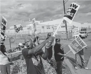  ?? JAKE MAY/THE FLINT JOURNAL VIA AP ?? Flint resident Jashanti Walker, who has been a first shift team leader in the body shop for two years, demonstrat­es with more than a dozen other General Motors employees outside of the Flint Assembly Plant on Sunday in Flint, Mich. The United Auto Workers union says its contract negotiatio­ns with GM have broken down, and its members will go on strike just before midnight Sunday.