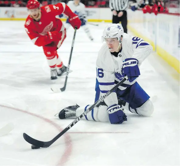  ?? — THE ASSOCIATED PRESS ?? Toronto’s Mitch Marner sweeps the puck away from Detroit Red Wings defenceman Nick Jensen on Sunday in Detroit.