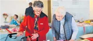  ??  ?? Norma Evans (left) admiring some of the entries in the WI handcraft exhibition.