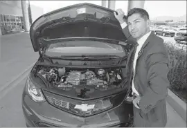  ?? Brian van der Brug Los Angeles Times ?? OF 250 VEHICLES that Community Chevrolet in Burbank sells each month on average, about a fifth are Volts and Bolts. Above, sales manager Oscar Gutierrez.