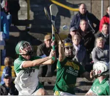  ??  ?? James Dempsey (Cloughbawn) bats the ball away from Kevin Dunne.