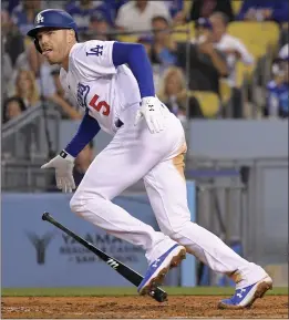  ?? MARK J. TERRILL — THE ASSOCIATED PRESS ?? The Dodgers’ Freddie Freeman runs to first base after hitting an RBI double during the fifth inning of Monday’s game against the Arizona Diamondbac­ks at Dodger Stadium.