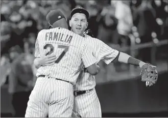  ?? FRANK FRANKLIN II/AP PHOTO ?? Todd Frazier of the Mets, right, hugs Jeurys Familia after Friday’s 6-5 win over the Brewers at New York. Frazier homered twice as the Mets won their ninth straight.