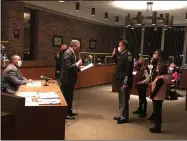  ?? RICHARD PAYERCHIN — THE MORNING JOURNAL ?? Lorain Mayor Jack Bradley, left, administer­s the oath of office to Lorain Police Sgt. A.J. Mathewson, who was promoted to rank of lieutenant, during the Lorain City Council meeting of Nov. 2, as police Chief James McCann looks on.