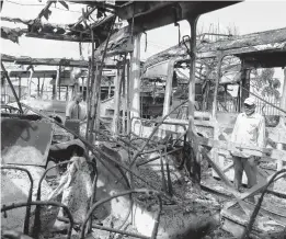  ?? SUNDAY ALAMBA/AP PHOTOS ?? The charred remains of buses Saturday in Lagos, Nigeria, after days of peaceful protests over police abuses turned deadly. A 24-hour curfew was loosened Saturday in the city.