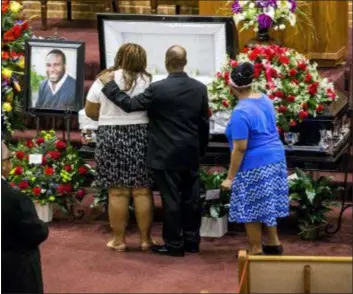  ?? SHABAN ATHUMAN/THE DALLAS MORNING NEWS VIA AP, FILE ?? In this Sept. 13 file photo, mourners console one another during the public viewing before the funeral of Botham Shem Jean at the Greenville Avenue Church of Christ in Richardson, Texas. Jean was shot and killed by Dallas police officer Amber Guyger in his apartment in Dallas. The former Dallas police officer has been indicted on a murder charge announced Friday, Nov. 30. Guyger was arrested days after the Sept. 6 shooting that killed 26-yearold Jean, who was from the Caribbean island nation of St. Lucia.