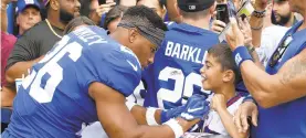  ?? MICHAEL OWENS/AP ?? Giants running back Saquon Barkley signs an autograph before Thursday’s preseason opener against the Jets in East Rutherford, New Jersey.