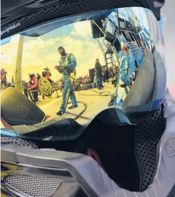  ?? JOHN LOCHER/AP ?? Pit crew members for driver Kyle Larson are reflected in a helmet during a NASCAR Cup Series on March 6 in Las Vegas.