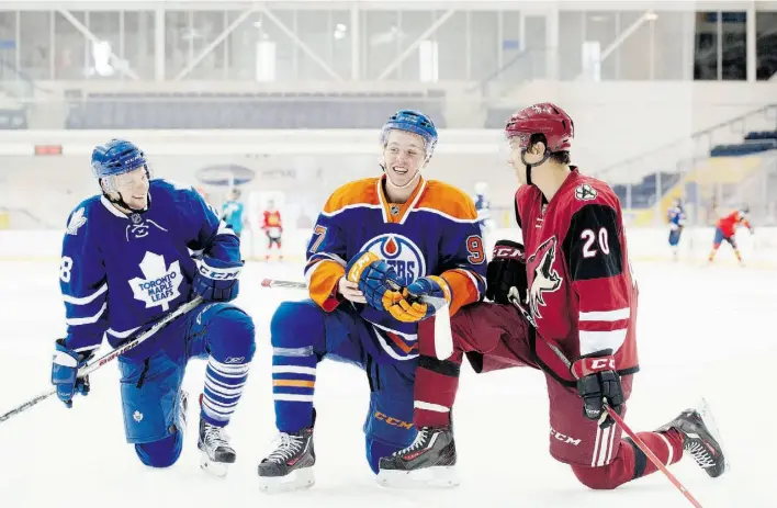  ?? DARREN CALABRESE/ THE CANADIAN PRESS ?? The Edmonton Oilers’ Connor McDavid, centre, is flanked by Toronto’s Connor Brown, left, and Arizona’s Dylan Strome at the NHLPA Rookie Showcase in Toronto on Tuesday.