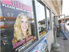  ?? ASSOCIATED PRESS FILE PHOTO ?? A poster offering a reward for informatio­n in the disappeara­nce of Holly Bobo is displayed in a store window in Parsons, Tenn., in 2014.