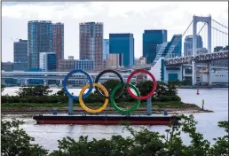  ?? KAZUHIRO NOGI/AFP/GETTY IMAGES/TNS ?? The Olympic rings are seen at the Odaiba waterfront in Tokyo on June 3. On Thursday, officials announced that spectators will not be allowed to attend the Summer Olympics.