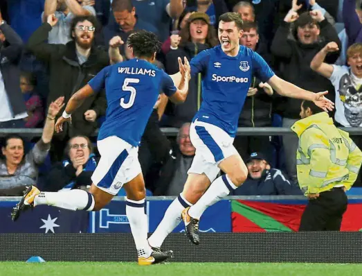  ??  ?? Right on target: Everton’s Michael Keane celebratin­g with Ashley Williams after scoring the first goal against Hajduk Split during the Europa League playoff at Goodison Park on Thursday. Everton won 2- 0. — Reuters