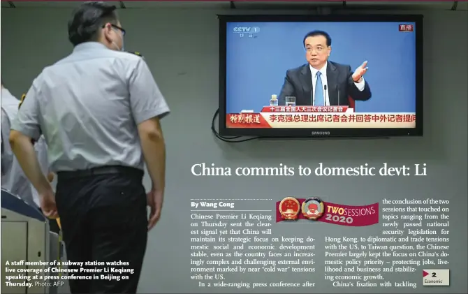  ?? Photo: AFP ?? A staff member of a subway station watches live coverage of Chinesew Premier Li Keqiang speaking at a press conference in Beijing on Thursday.