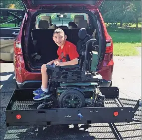  ?? Contribute­d photo ?? Patrick Blanchette on the metal platform newly installed on the back of the family car to transport his power wheelchair and adaptive bicycle.