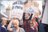  ?? MARY ALTAFFER/THE ASSOCIATED PRESS ?? Kayla Forshey, left, participat­es in a rally to condemn Republican presidenti­al candidate Donald Trump’s remarks about women and abortion on Thursday, in New York.