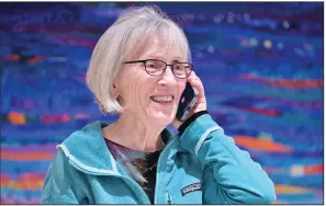  ?? (AP/Josh Reynolds) ?? Claudia Goldin, a professor at Harvard University, speaks to a reporter on the phone Monday in her home in Cambridge, Mass., after learning that she received the Nobel Prize in Economics.