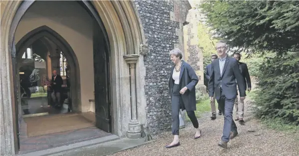  ??  ?? 0 Try praying: Theresa May and her husband Philip arrive at St Andrew’s Church in Sonning, Berkshire, perhaps looking for some divine inspiratio­n