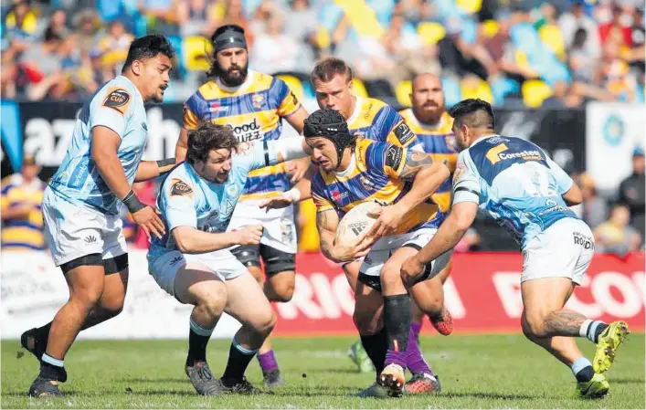  ?? Photos / Getty Images ?? Northland defenders close in on Trael Joass of Bay of Plenty during a Mitre 10 Cup match in Tauranga.