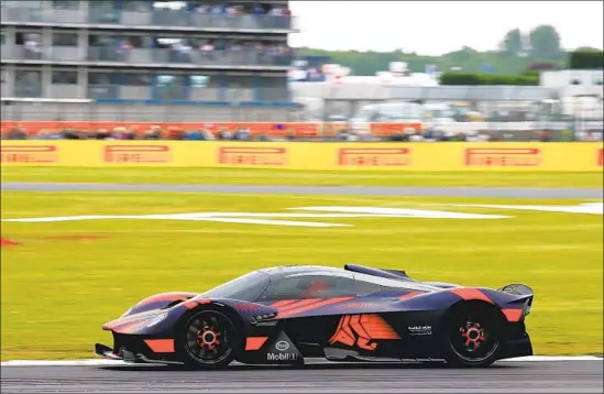  ?? Charles Coates Getty Images ?? MANY SUPERCARS are limited edition and sell out before they’re seen. Above, a driver practices with Aston Martin’s Valkyrie before the British Grand Prix in July.