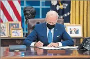  ?? [EVAN VUCCI/ASSOCIATED PRESS FILE PHOTO] ?? In this Feb. 2 photo, President Joe Biden signs an executive order in the Oval Office of the White House in Washington.