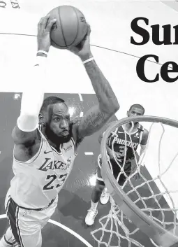  ??  ?? BREAKAWAY JAM — LeBron James of the Los Angeles Lakers (left) dunks the ball during the game against the Phoenix Suns yesterday at Staples Center in Los Angeles, California. The Sun won, 114-104. (AFP)