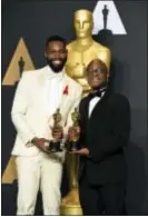  ?? ASSOCIATED PRESS ?? Tarell Alvin McCraney, left, and Barry Jenkins, winners of the award for best adapted screenplay for “Moonlight,” pose in the press room at the Oscars on Sunday at the Dolby Theatre in Los Angeles.