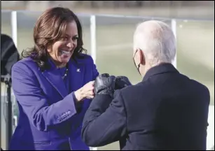  ?? ASSOCIATED PRESS ?? Vice President Kamala Harris bumps fists with President-elect Joe Biden after she was sworn in during the inaugurati­on Wednesday at the US Capitol in Washington.