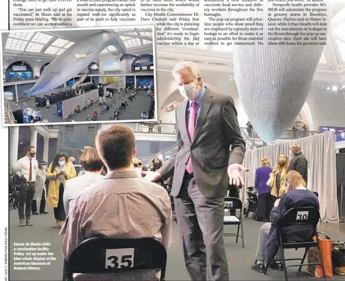  ??  ?? Mayor de Blasio visits a vaccinatio­n facility Friday set up under the blue whale display at the American Museum of Natural History.