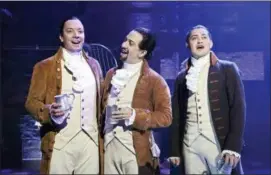  ?? ANDREW LIPOVSKY — NBC VIA AP ?? This image released by NBC shows Jimmy Fallon, host of “The Tonight Show Starring Jimmy Fallon,” left, with Lin-Manuel Miranda, center, and a member of the cast from the musical “Hamilton,” at the Luis A. Ferré Performing Arts Center in San Juan, Puerto Rico.