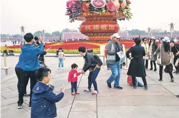  ??  ?? Chinese tourists play in Tiananmen square during the Communist Party’s 19th Congress. — AFP photo