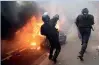  ?? AFP ?? A riot police throws teargas during protests in Paris. —