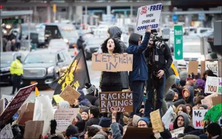  ?? BRYAN R SMITH/AFP ?? Protesters gather at JFK Internatio­nal Airport against Donald Trump’s executive order, on Saturday, in New York.