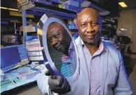  ?? NELVIN C. CEPEDA U-T ?? Roswell Biotechnol­ogies’ Paul Mola, holding a silicon chip wafer, is one of San Diego’s few Black biotech CEOS.