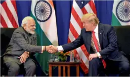  ?? — PTI ?? Prime Minister Narendra Modi shakes hand with US President Donald Trump during a bilateral meeting in Manila, Philippine­s, on Monday.