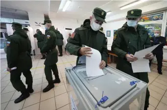 ?? AP ?? CASTING BALLOTS: Russian Army soldiers vote during the elections outside St. Petersburg Friday.