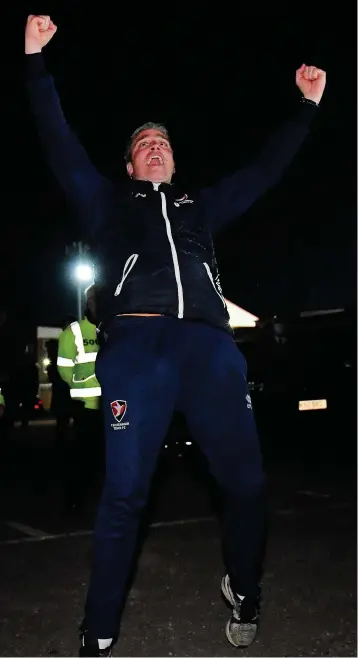  ??  ?? Michael Duff celebrates in the car park following promotion to League One