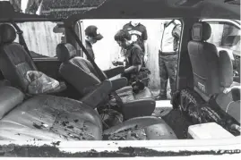  ?? (Jun Ryan Arañas ) ?? CRIME scene investigat­ors examine the van where businessma­n Jose Luis Yulo and his driver, Allan Nomer Santos, died during an ambush pulled by two motorcycle-riding gunmen on EDSA in Mandaluyon­g City Sunday afternoon.