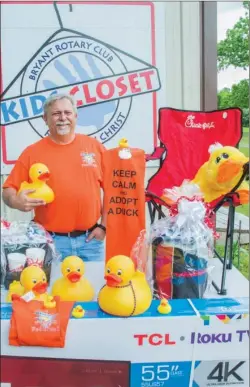  ?? WILLIAM HARVEY/TRILAKES EDITION ?? Bryant Rotary Club President David Hannah stands with some of the items available for the winners of the first ever Bryant Rotary Rubber Duck Derby. The derby will be May 6 at Mills Park in Bryant with proceeds going towards the Kids Closet, which...