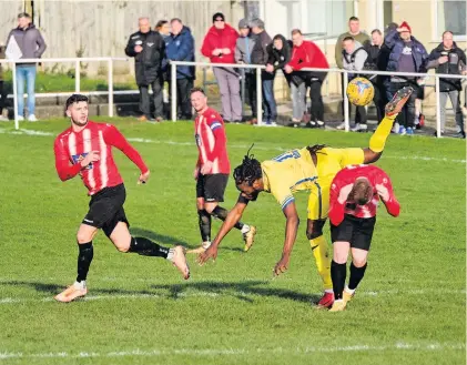  ?? Picture: Dave Betts ?? A Sutton Common Rovers player takes a tumble during the FA Vase fifth-round tie at Bitton, who won 2-1 to move into the quarter-finals - see Pages 6-7