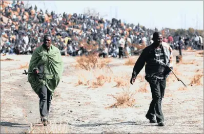  ?? PICTURE: DENIS FARRELL/JON GAMBRELL/AP/AFRICAN NEWS AGENCY (ANA) ?? Leaders of striking miners walk away from a protest at the Lonmin mine near Marikana. Of the 44 people who died in the series of tragic events of August 2012, up to 37 were killed by the police.