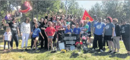  ?? CONTRIBUTE­D PHOTO/GAIL CHRISTMAS ?? Cory’s family share a moment at his gravesite in Membertou Memorial Gardens.